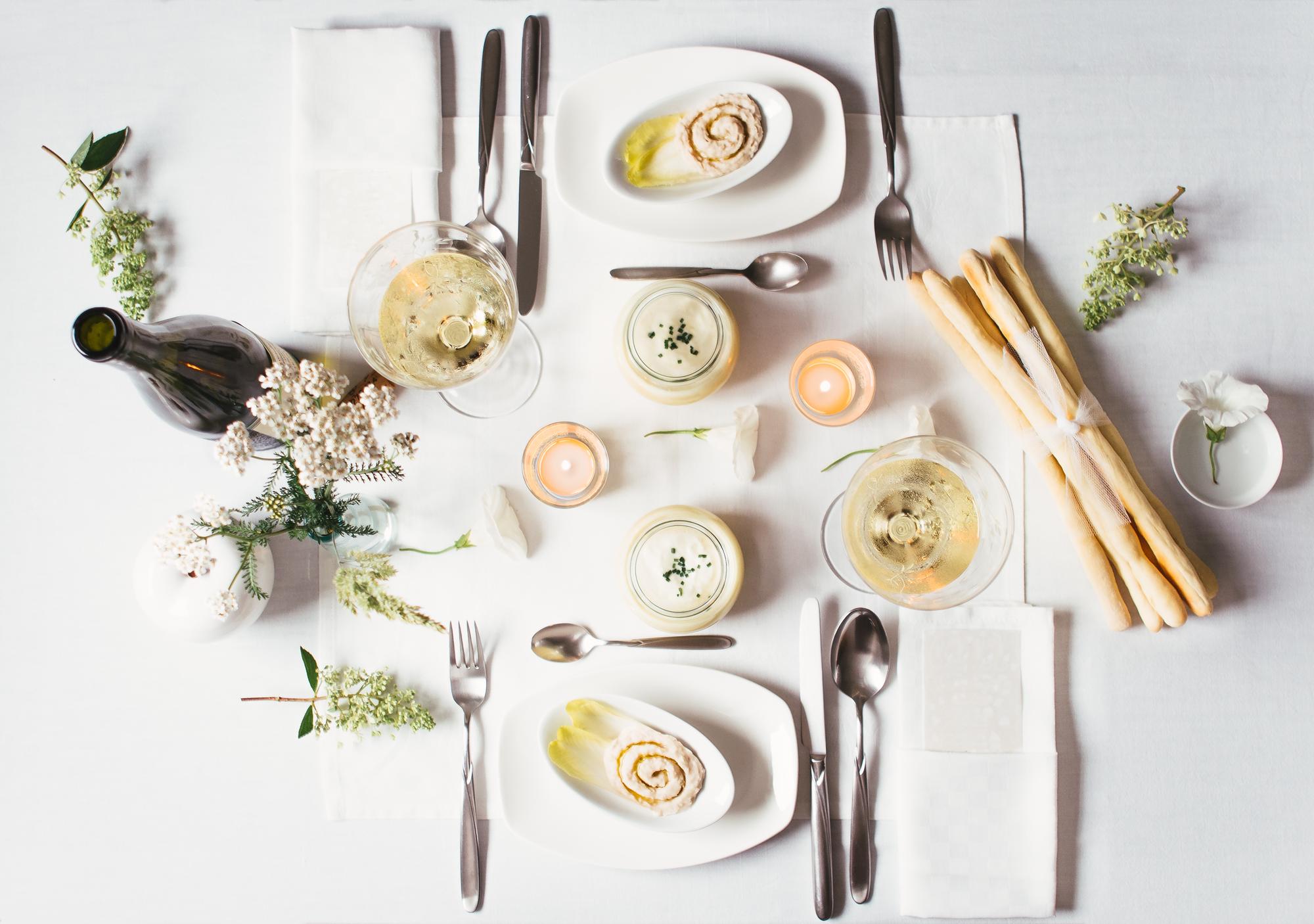 Set table with plated tasting courses and linen